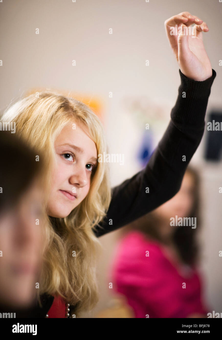 Schoolgirl putting up her arm, Sweden. Stock Photo