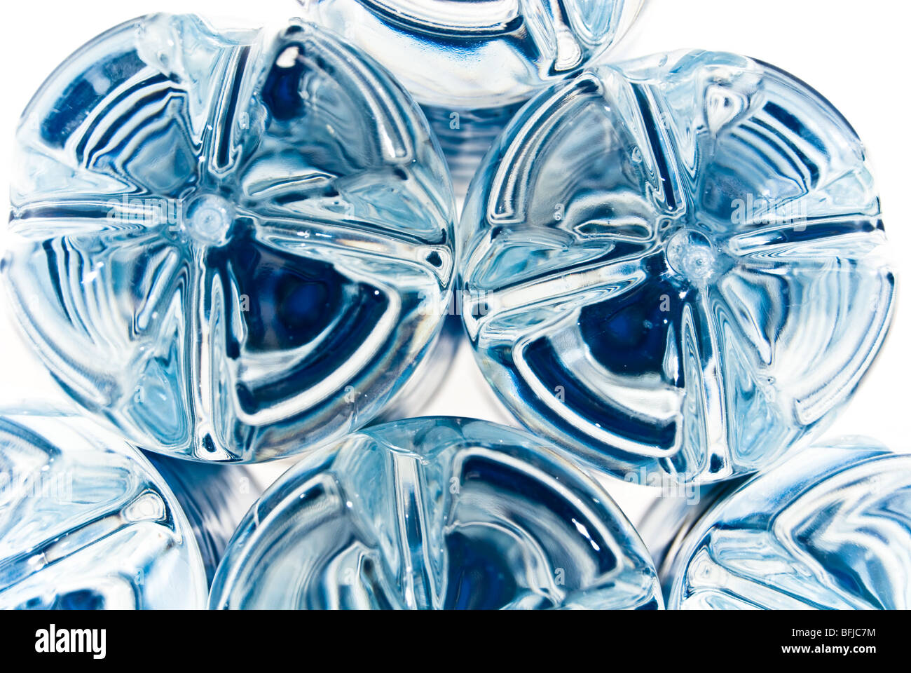 Moulded plastic bottle bottoms with a blue reflection from labels Stock