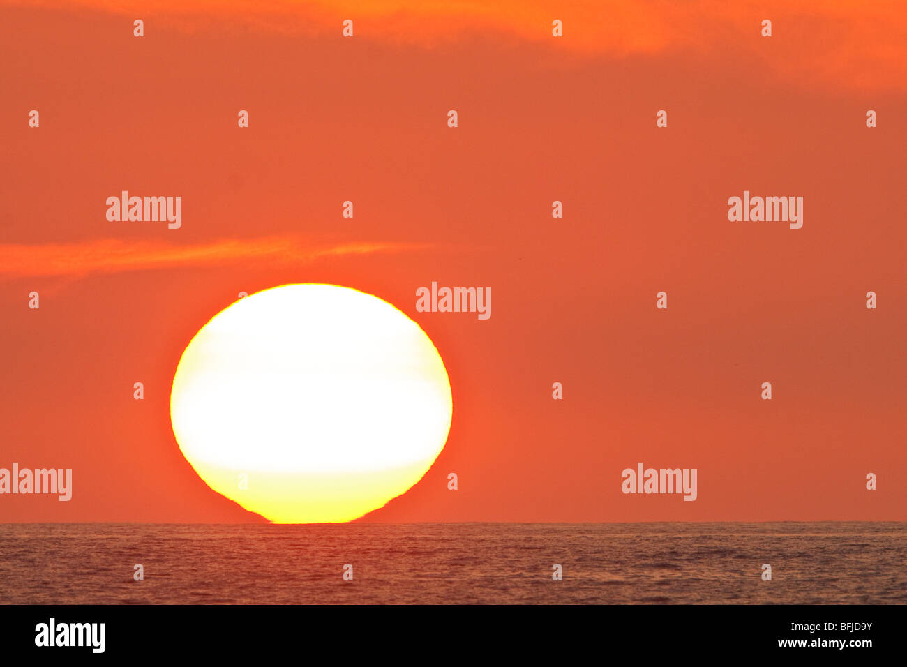 The sun sets over the Pacific Ocean along the coast of central Ecuador. Stock Photo