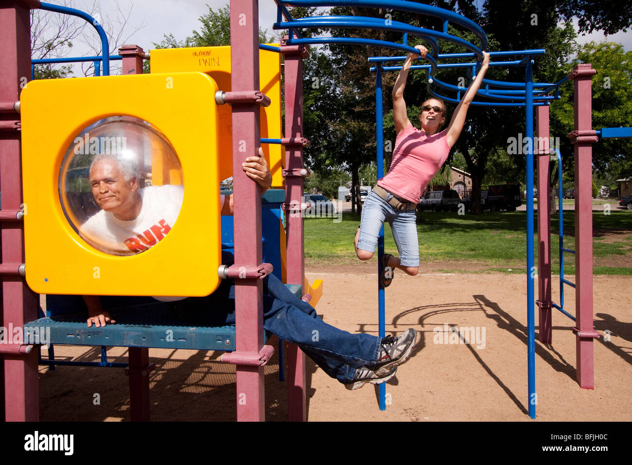 Adults playing on playground equipment in Western Kansas USA