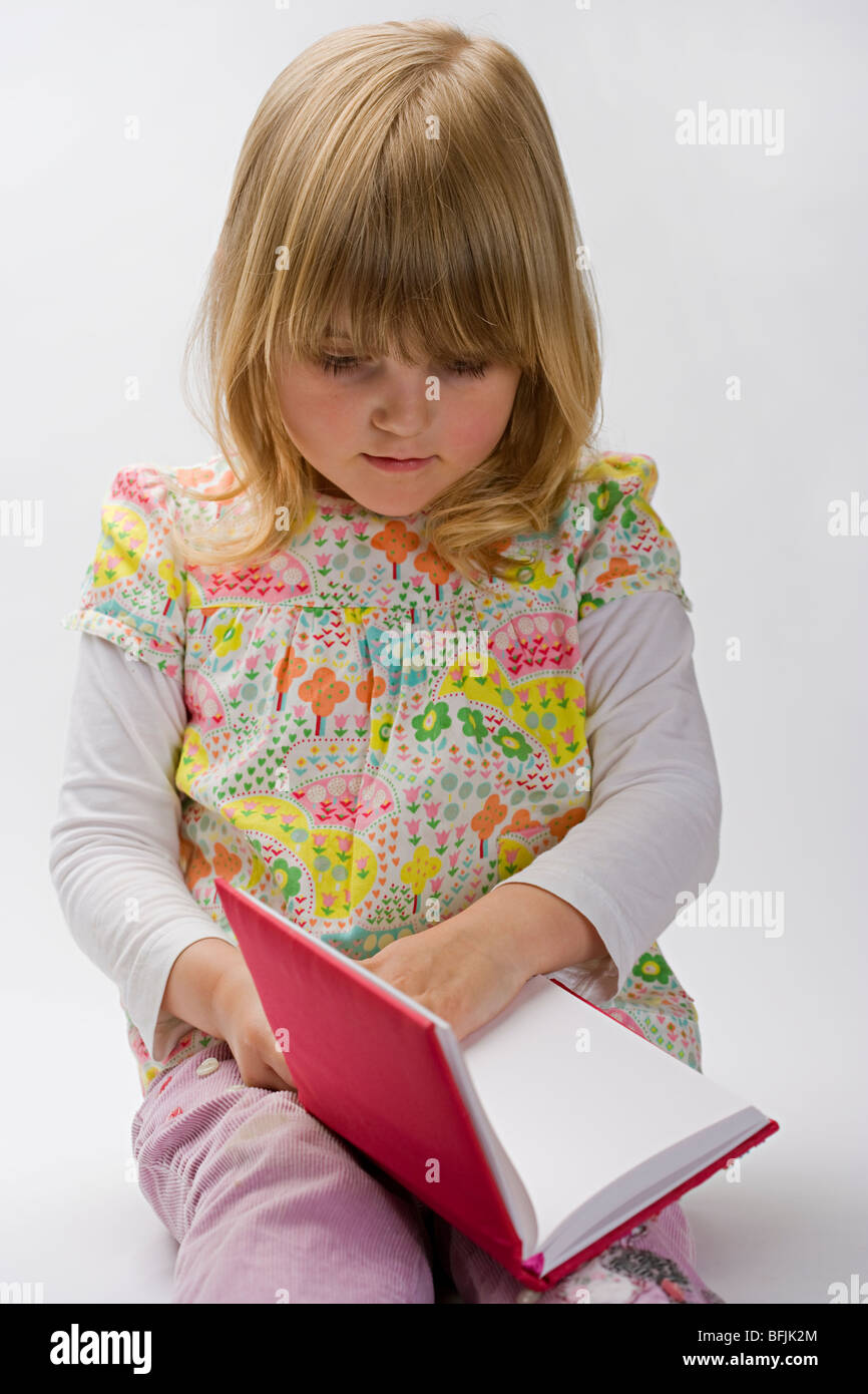 young girl reading a book Stock Photo