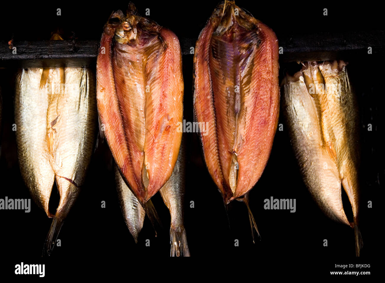 Kippers are hung, using traditional methods, at Whitby in North Yorkshire, England. Stock Photo