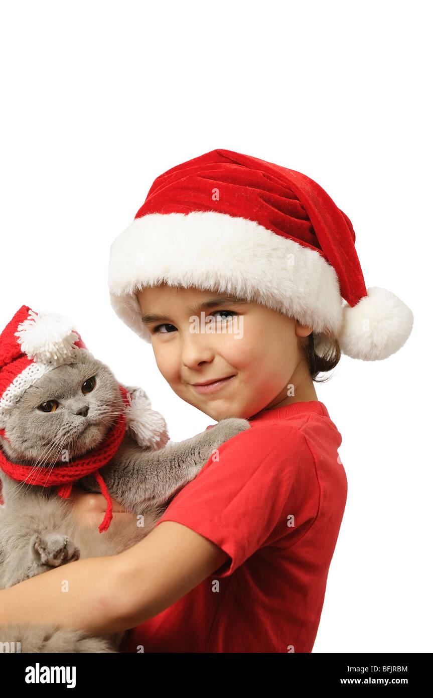 Young boy in santa hat with  cat on white background Stock Photo