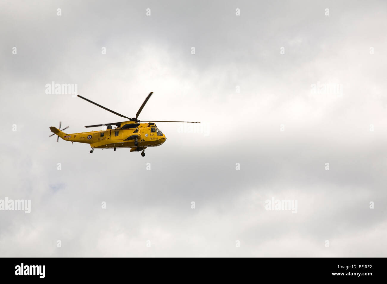 A yellow Sea King helicopter in flight. Such helicopters are used for emergency rescue missions. Stock Photo