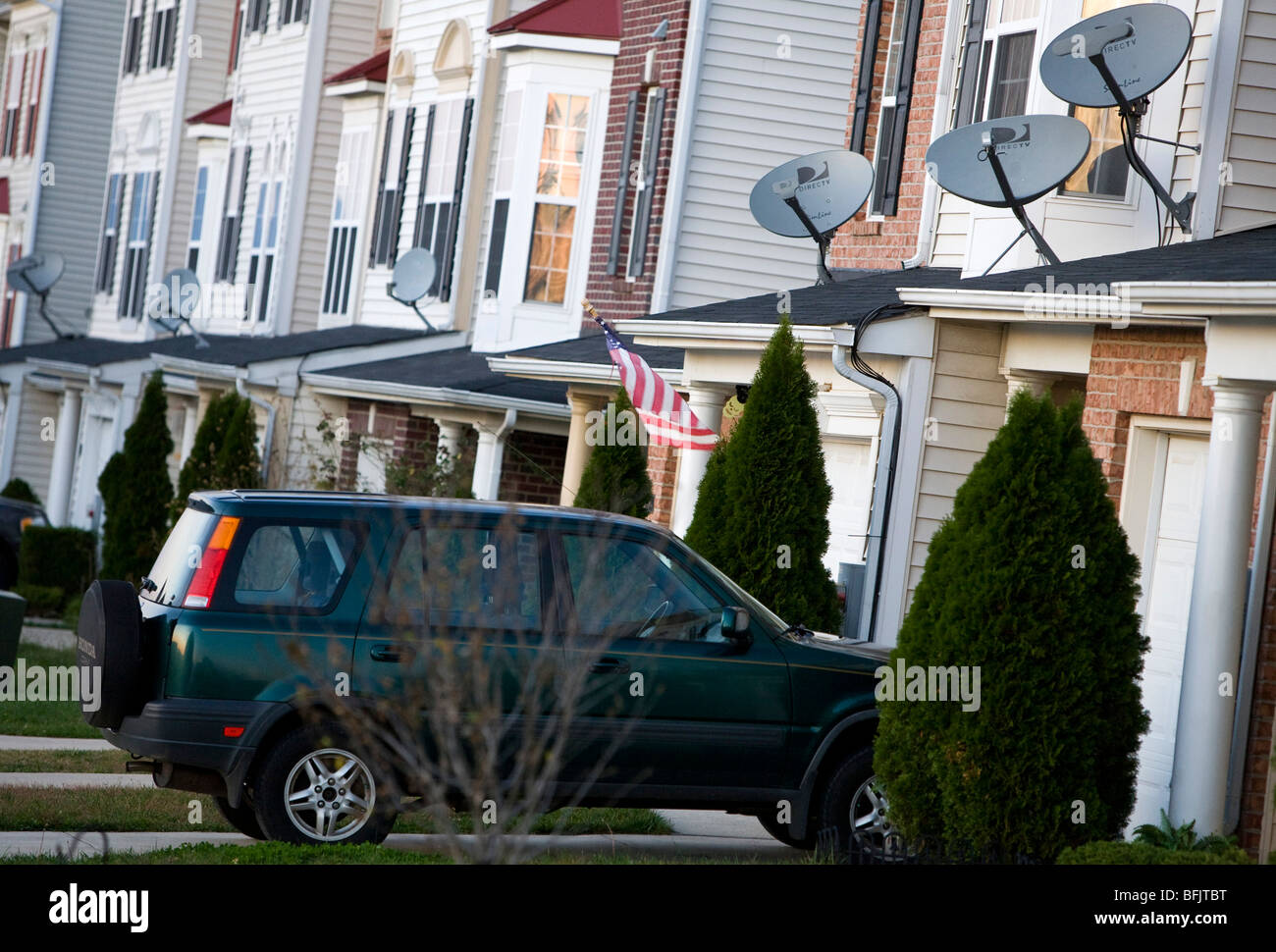 DirecTV satellite dishes in a suburban housing community.  Stock Photo
