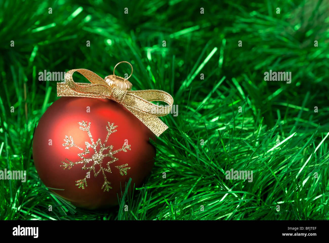 Red christmas balls on the green tinsel. aRGB. Stock Photo