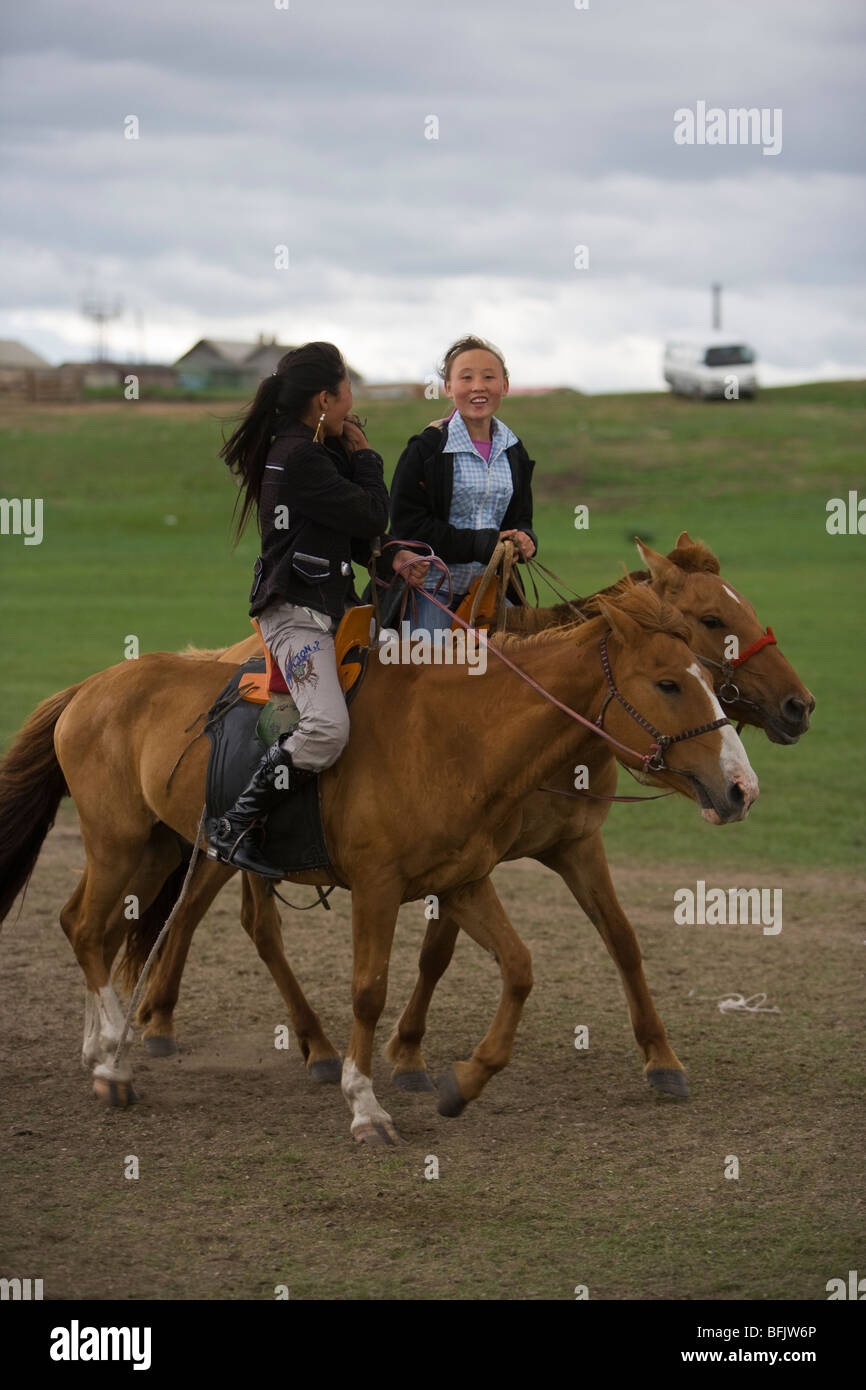 mongolian-girls-riding-horses-during-a-n