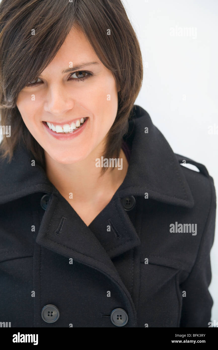 Hispanic woman in winter coat smiling Stock Photo Alamy