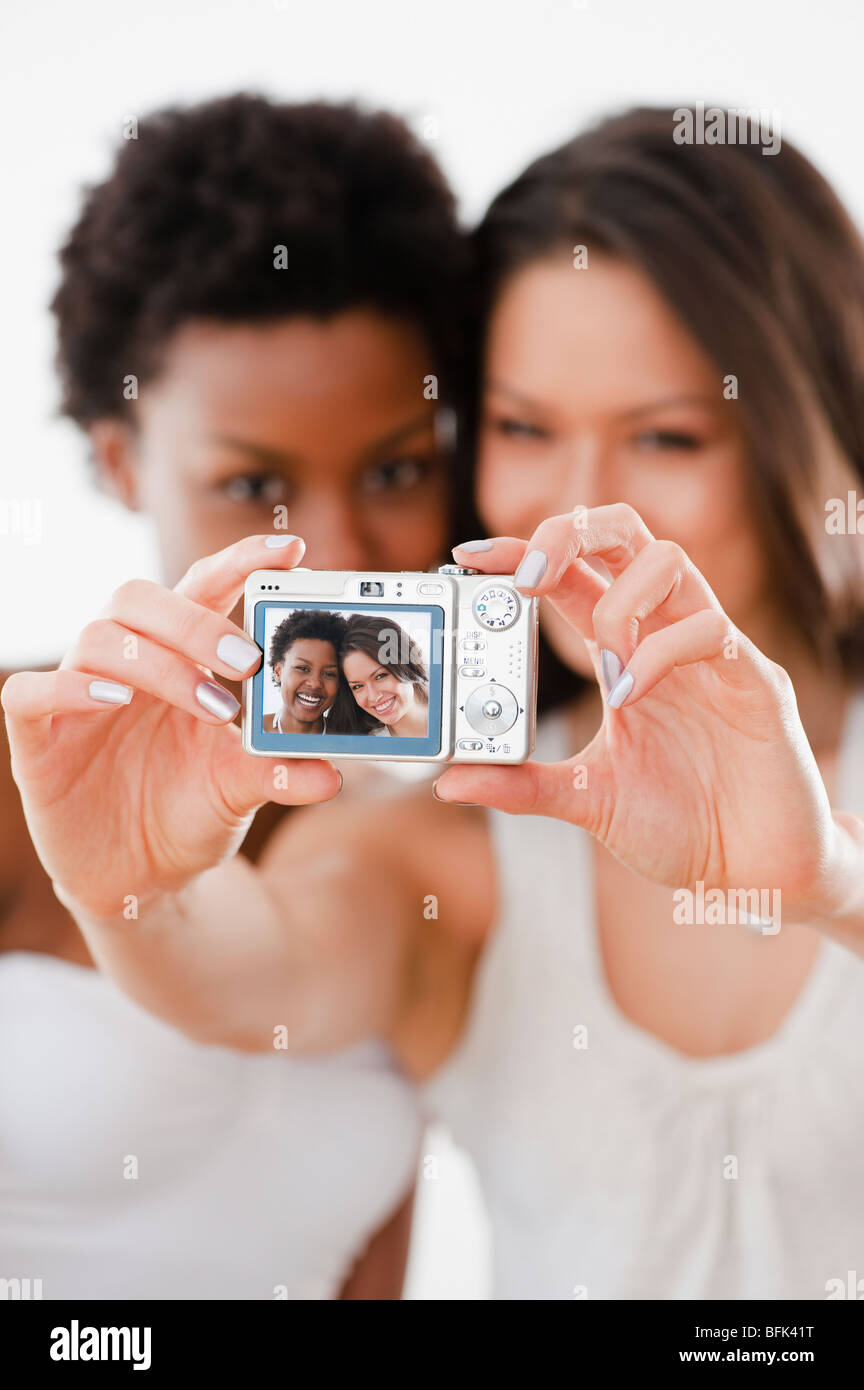 Friends taking self-portrait with digital camera Stock Photo