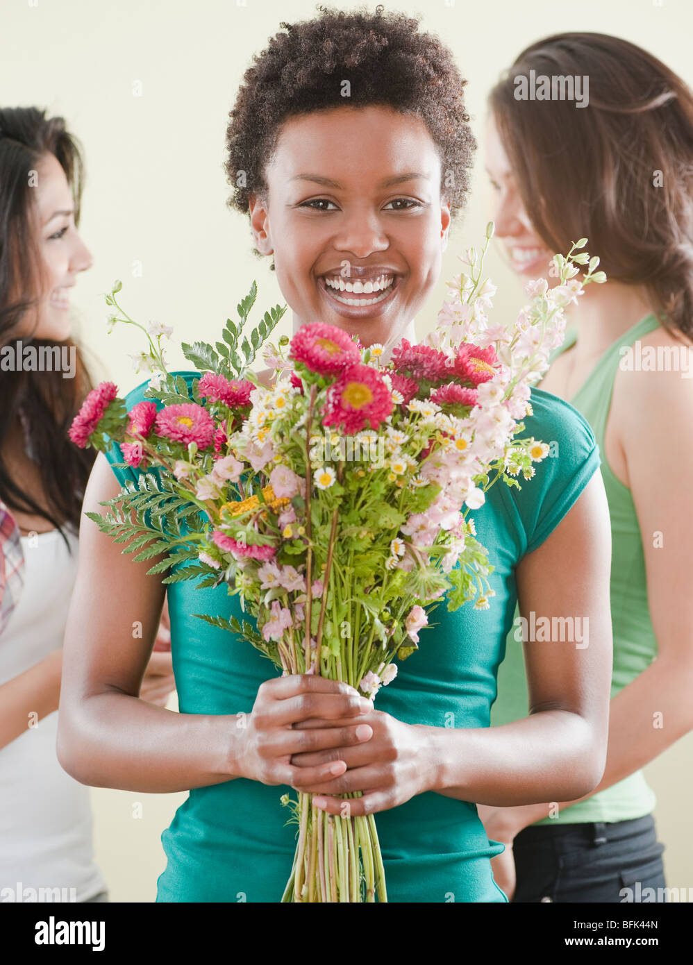 African woman holding bouquet of flowers Stock Photo - Alamy