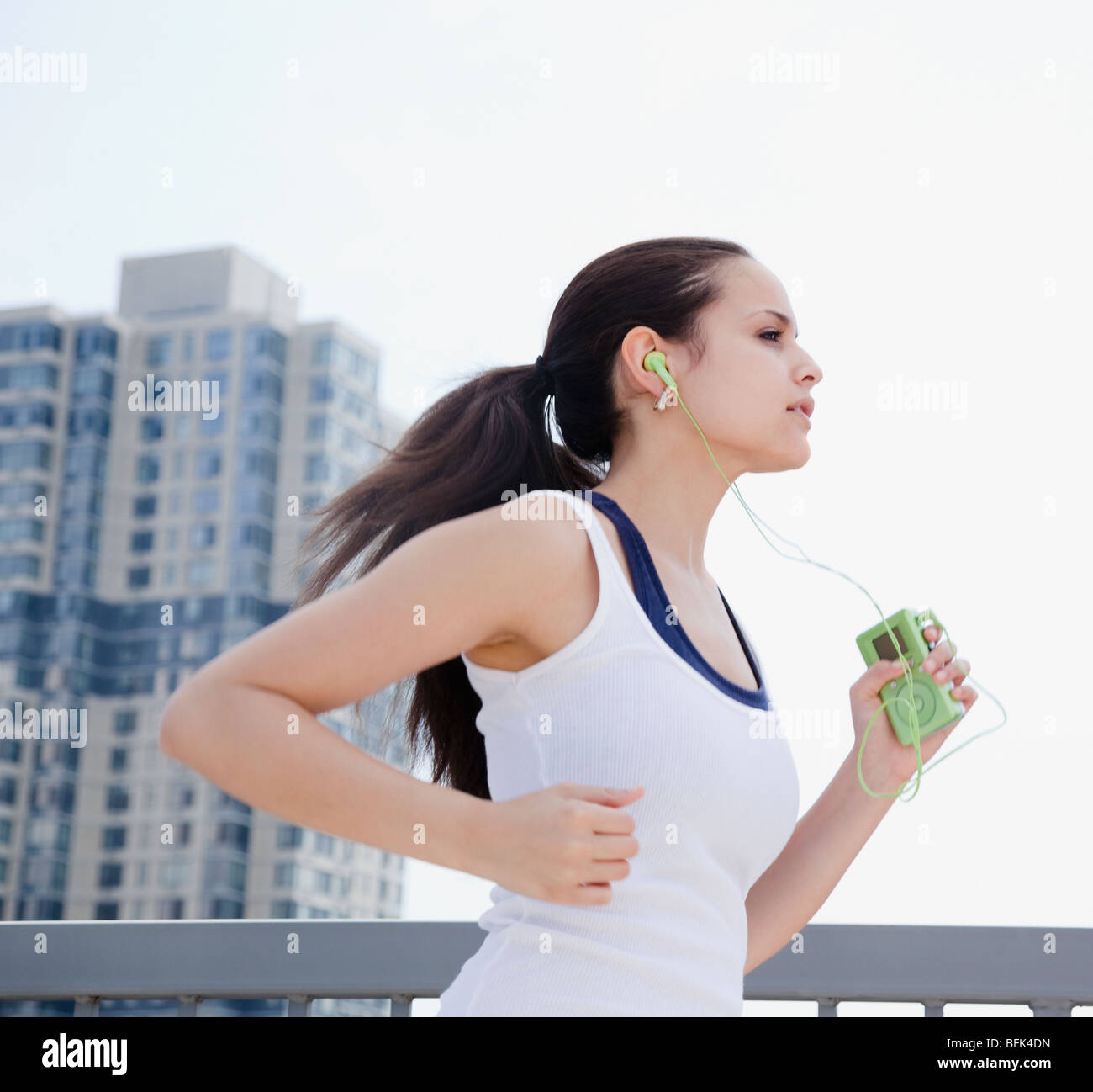 Mixed race woman jogging with mp3 player Stock Photo Alamy