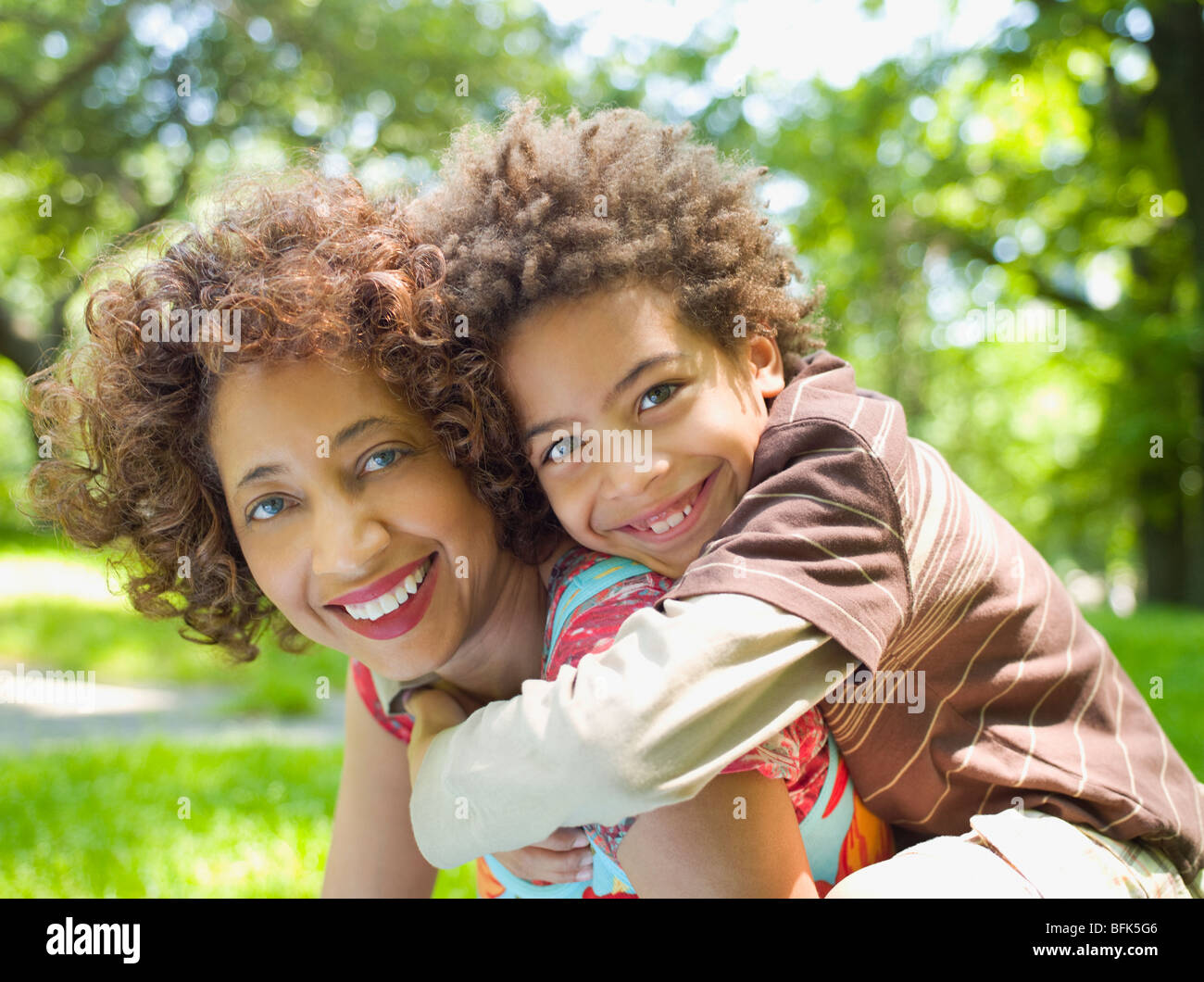 Mother giving son piggy back ride Stock Photo