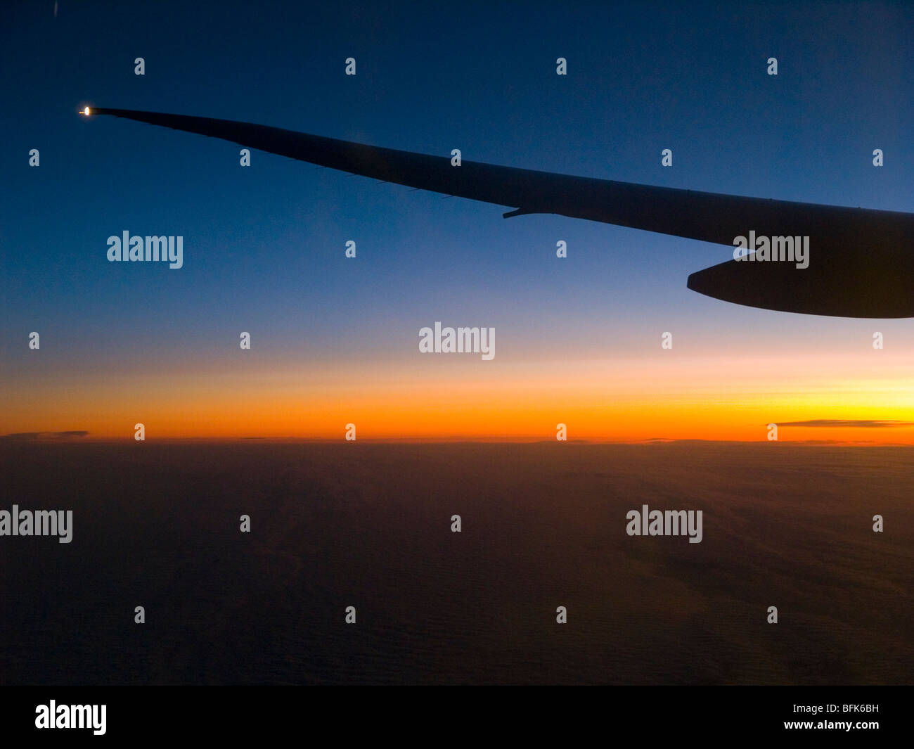 Sunrise viewed from the window of an aeroplane. Stock Photo