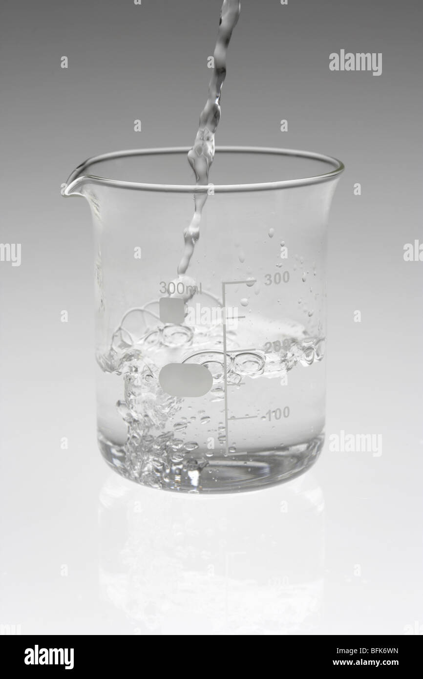 Liquid being poured into beaker Stock Photo - Alamy