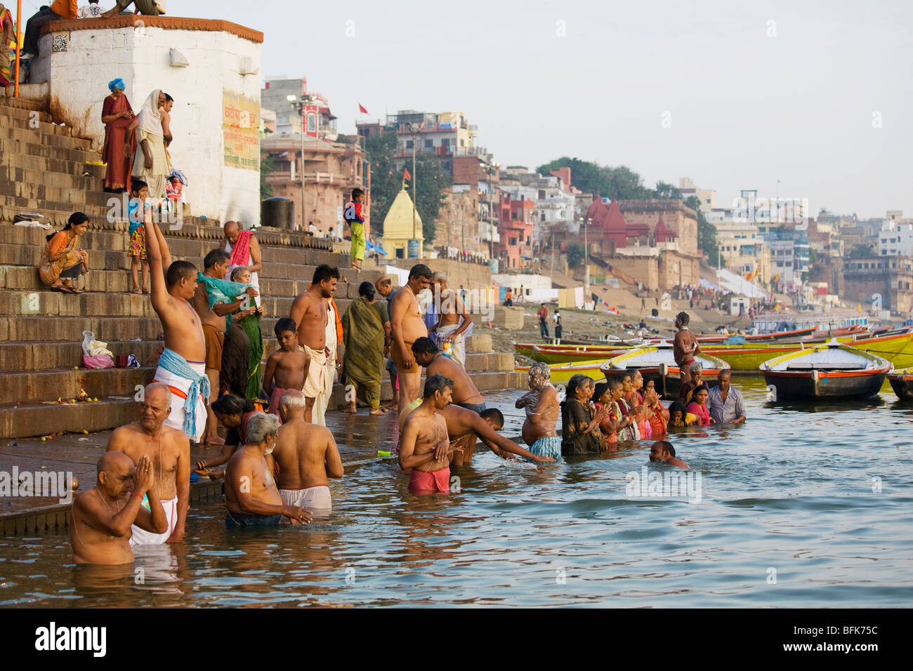 People come to pray and bathe in the early morning in the Ganges River at the Hindu holy city of Varanasi, India Stock Photo