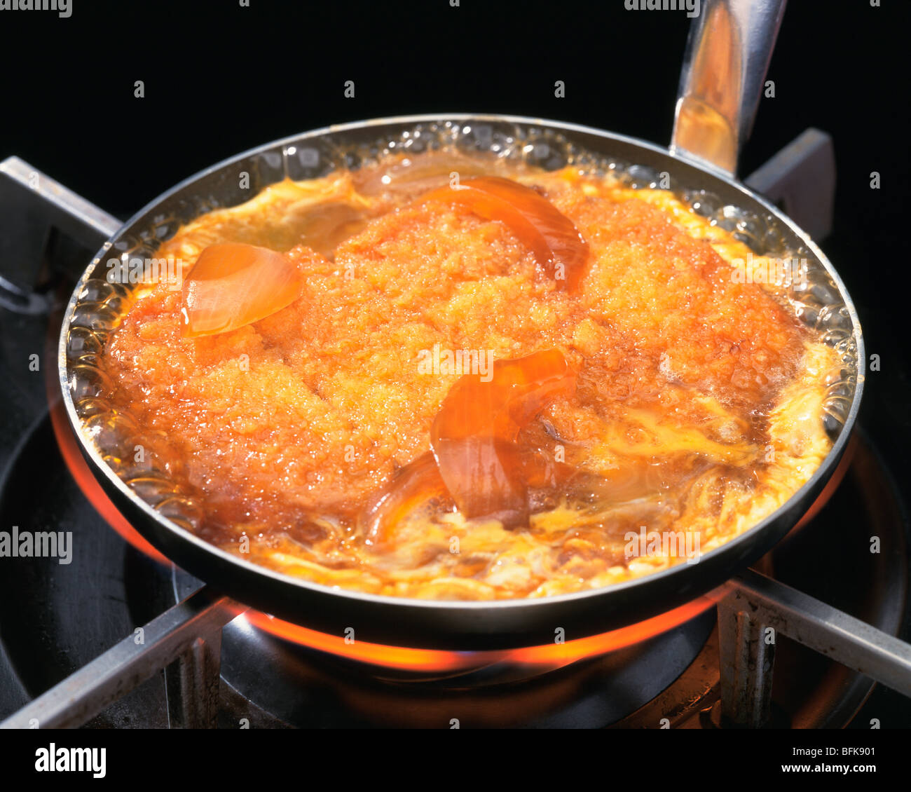 Deep fried pork being cooked in pan Stock Photo