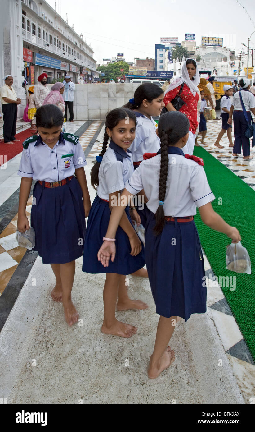 Schoolgirls washing their feet before entering The Golden Temple ...