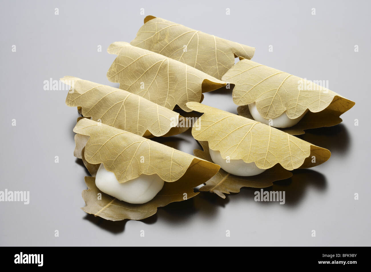 Wagashi wrapped in leaves black background Stock Photo Alamy