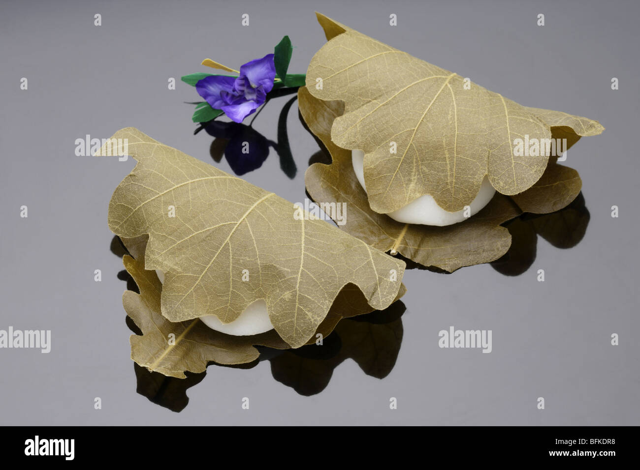 Wagashi wrapped in leaves black background Stock Photo Alamy