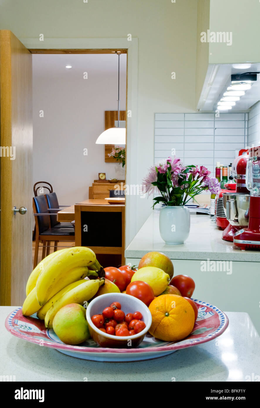 Bowl of fruit and tomatoes on a modern kitchen worktop Stock Photo
