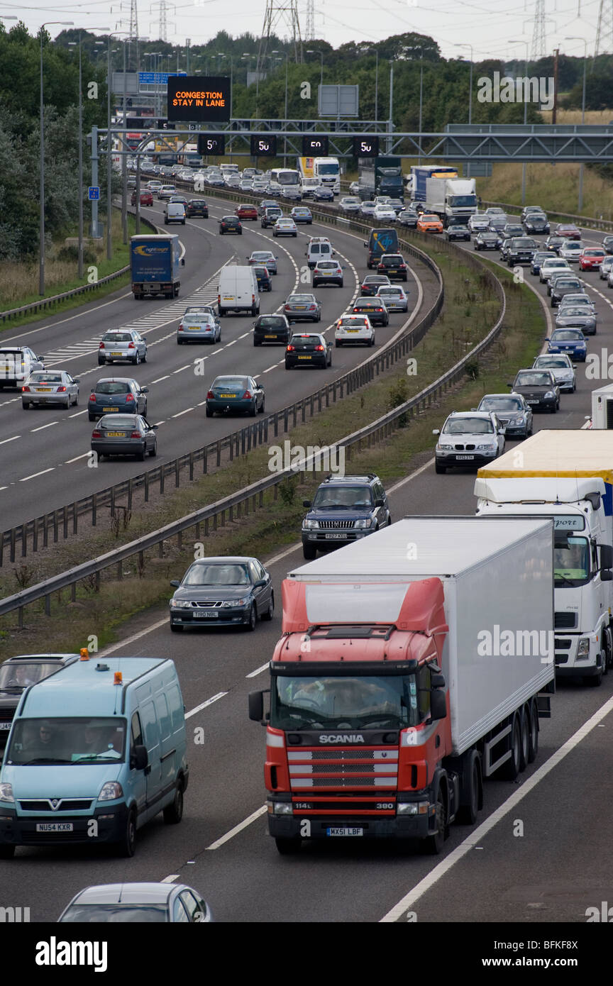 Variable speed limit section of the M42 showing traffic using the hard shoulder in attempt to ease congestion at rush hour. Stock Photo