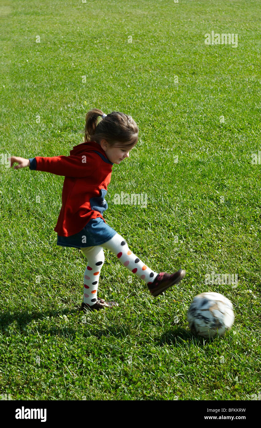 girl kicks a ball Stock Photo Alamy