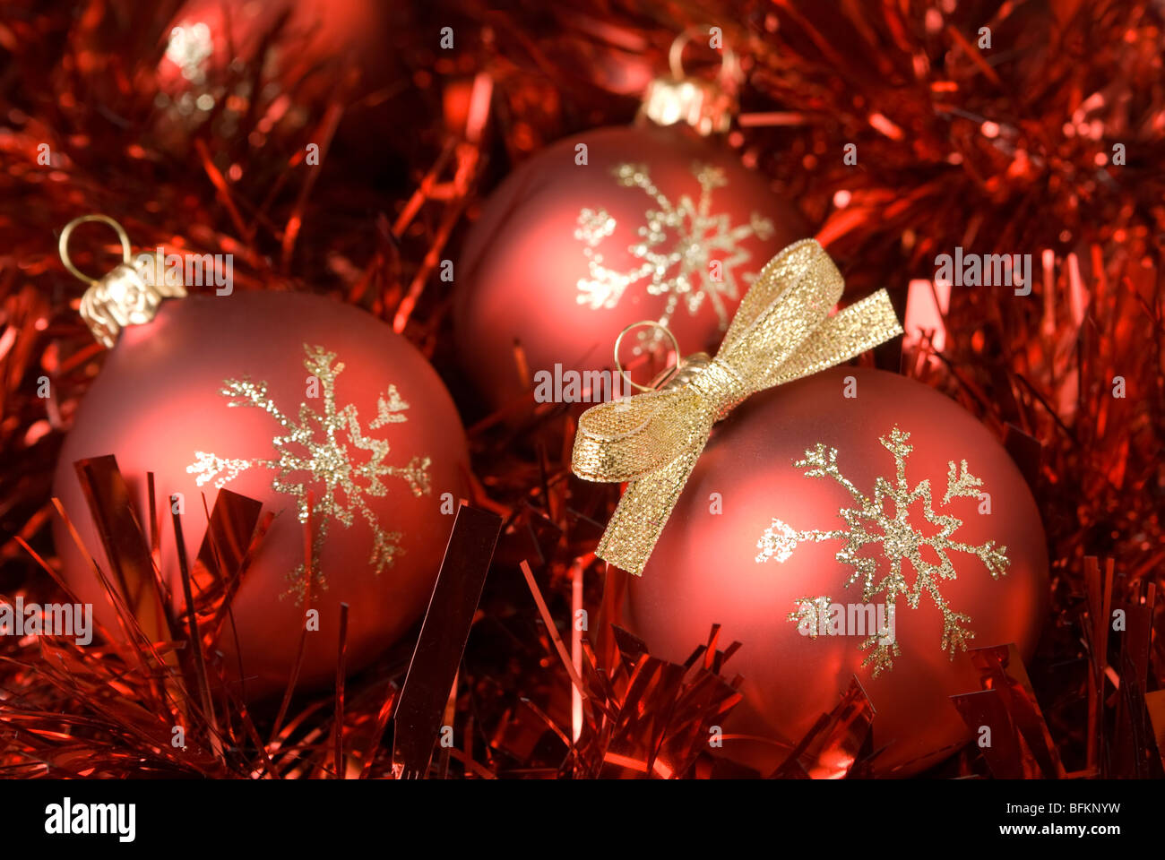 Red christmas ball on the tinsel. aRGB. Stock Photo