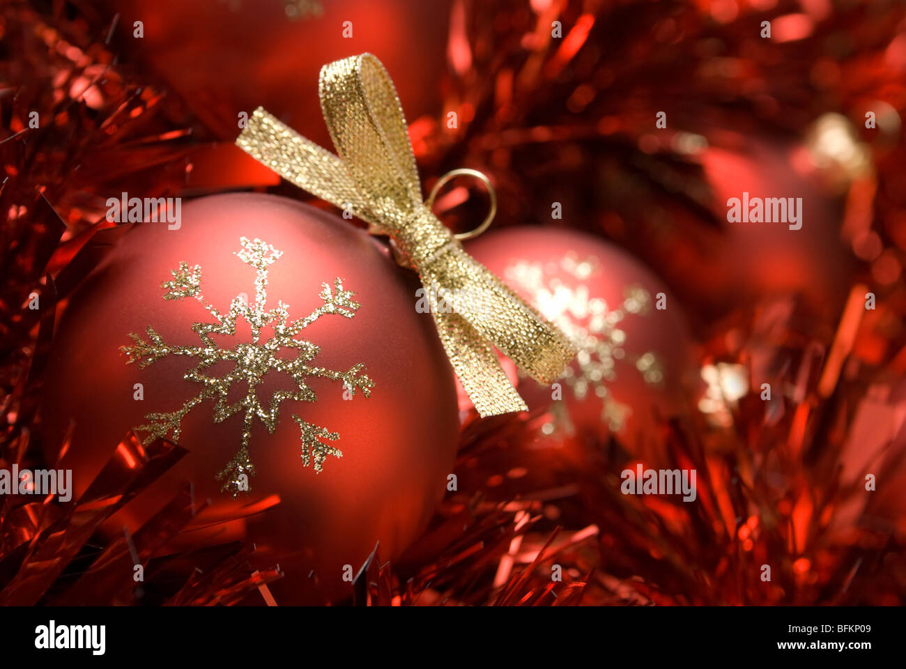 Red christmas ball on the tinsel. aRGB. Stock Photo
