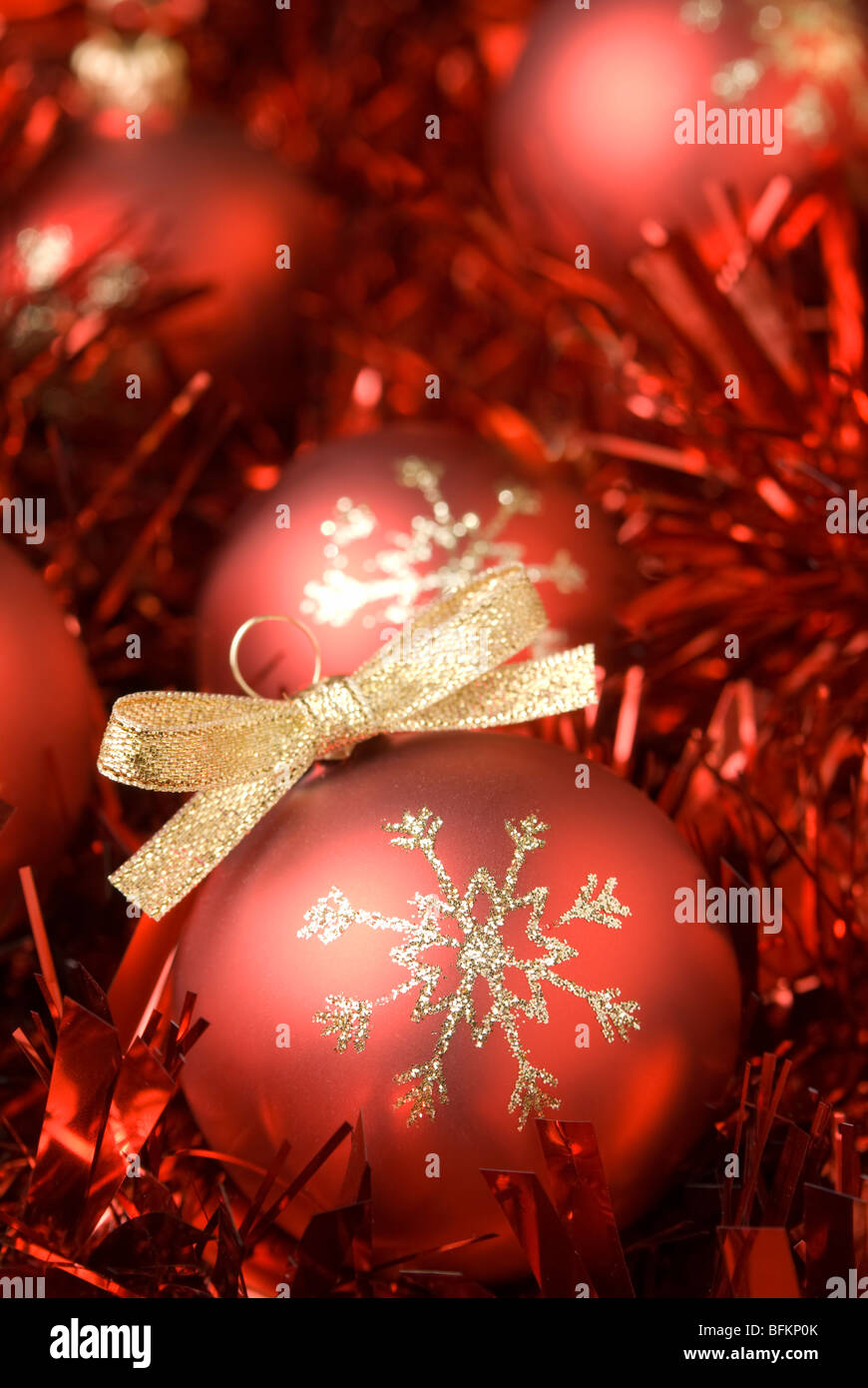 Red christmas ball on the tinsel. aRGB. Stock Photo