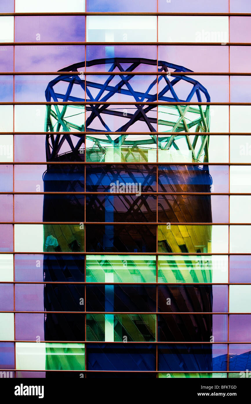 Reflected image of the Lowry tower cafe in the blue tinted windows of the offices that are opposite Stock Photo