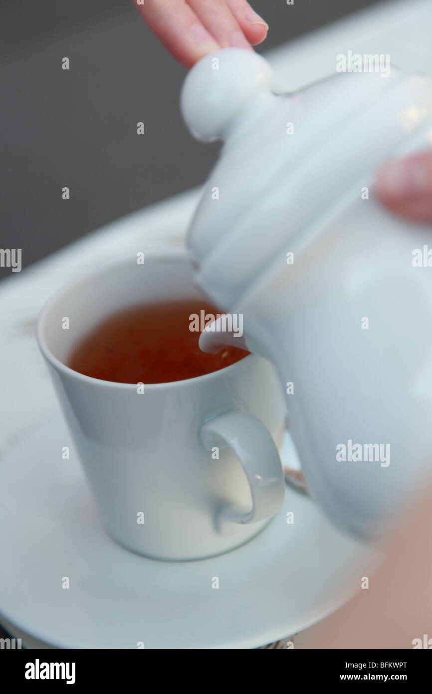 Tea time - filling a cup Stock Photo - Alamy