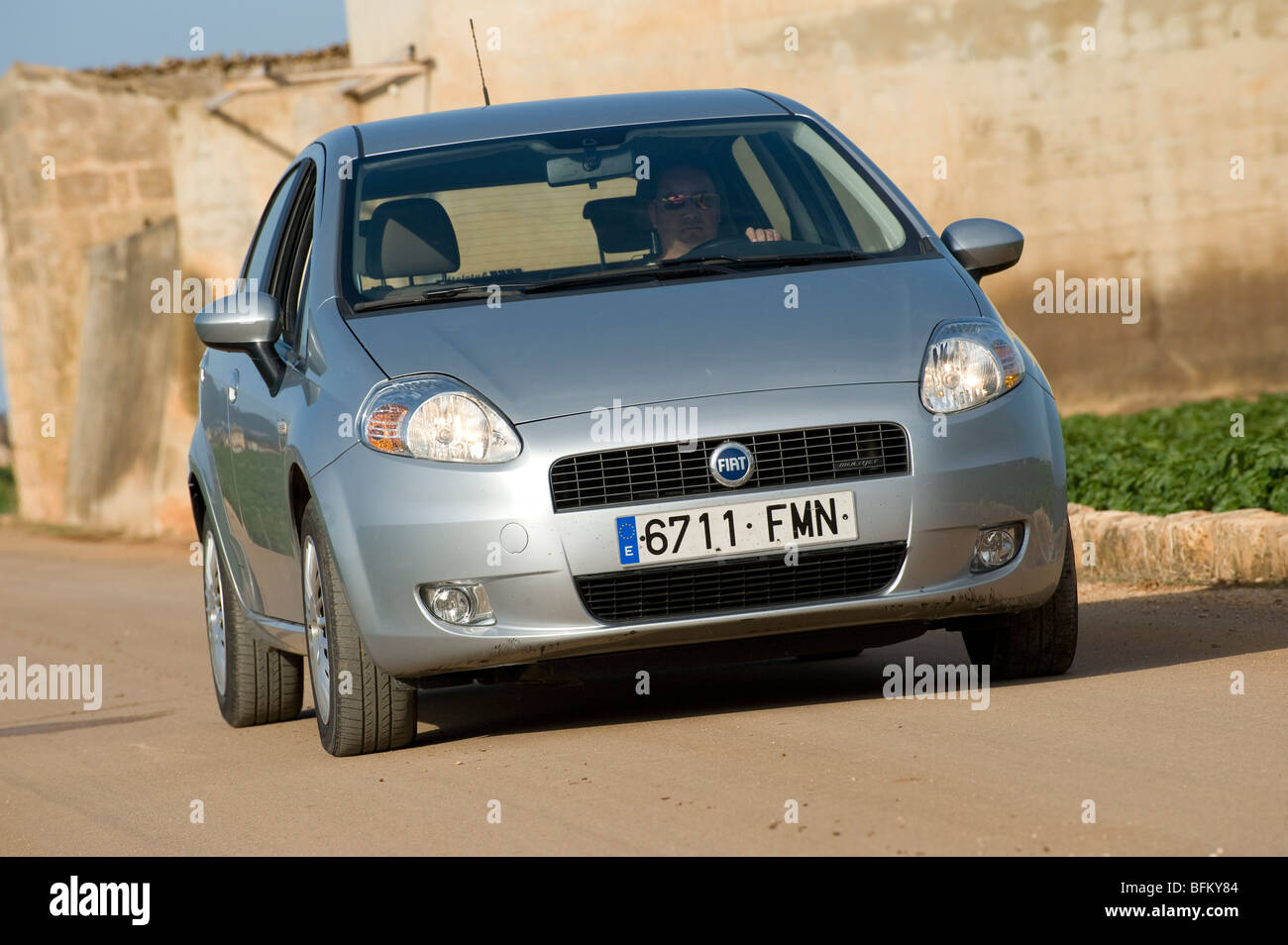 Silver Fiat Punto being driven along a road in Mallorca, Majorca, Spain. Stock Photo