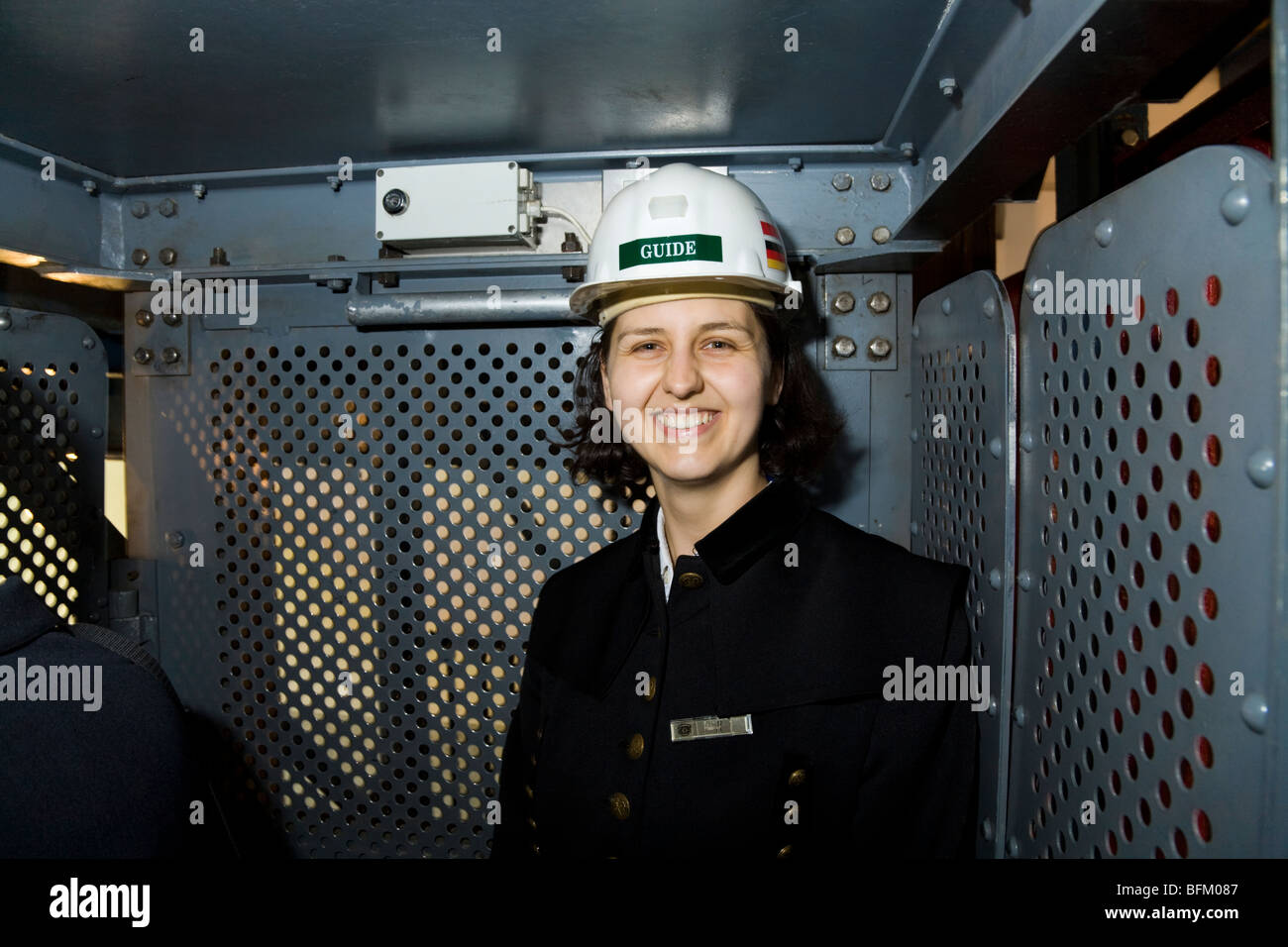 Smiling operator / guide of the elevator lift cage in the exiting shaft