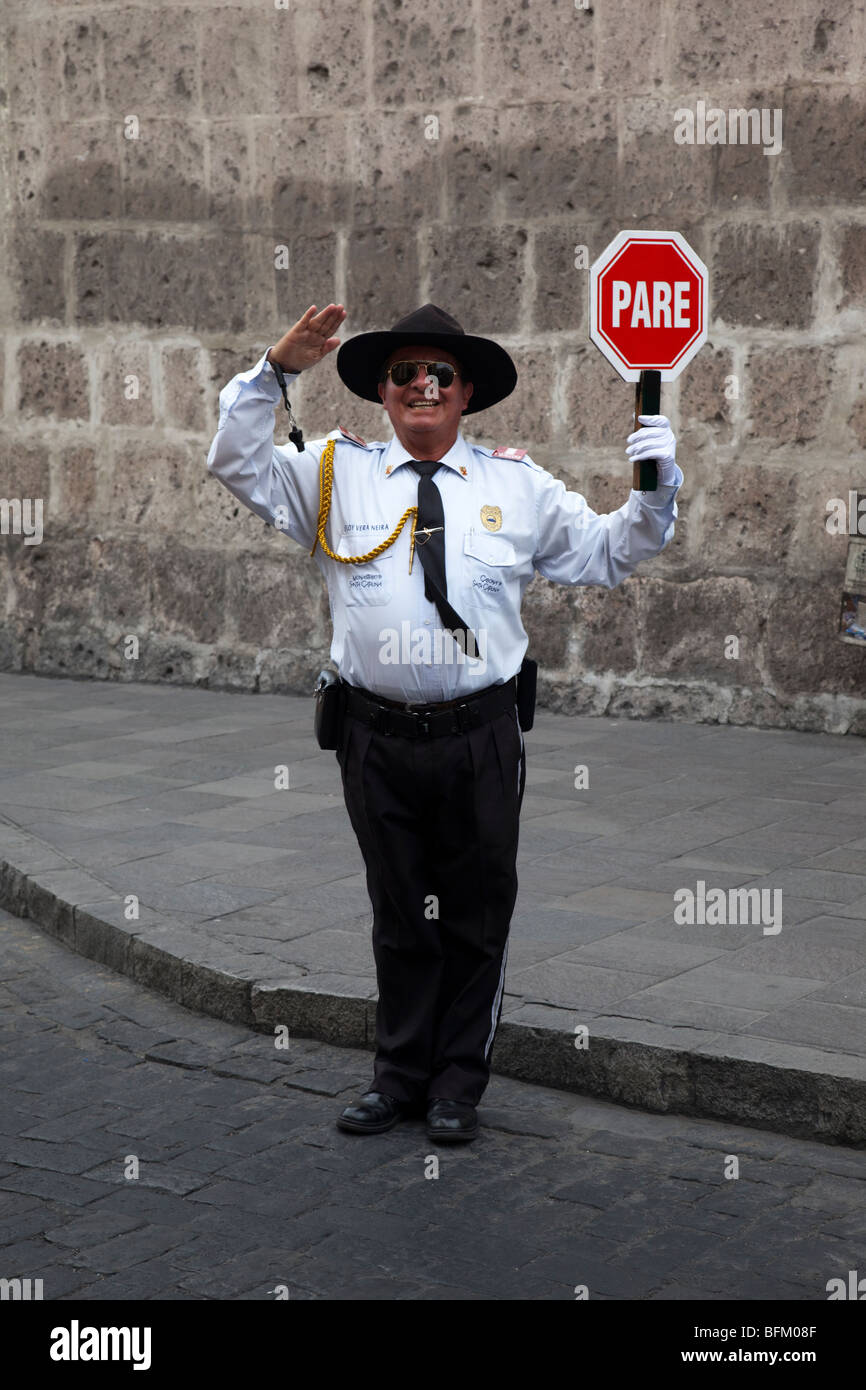 Man in uniform directing the traffic in Arequipa, Peru, South America. Could easily be mistaken for a traffic policeman, cop. Stock Photo