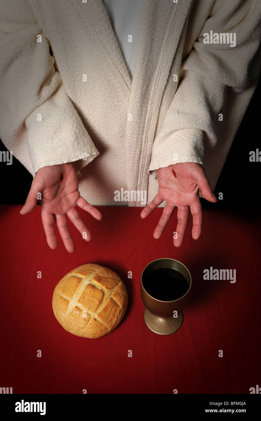 Jesus hands with scars offering the Communion elements of bread and wine Stock Photo