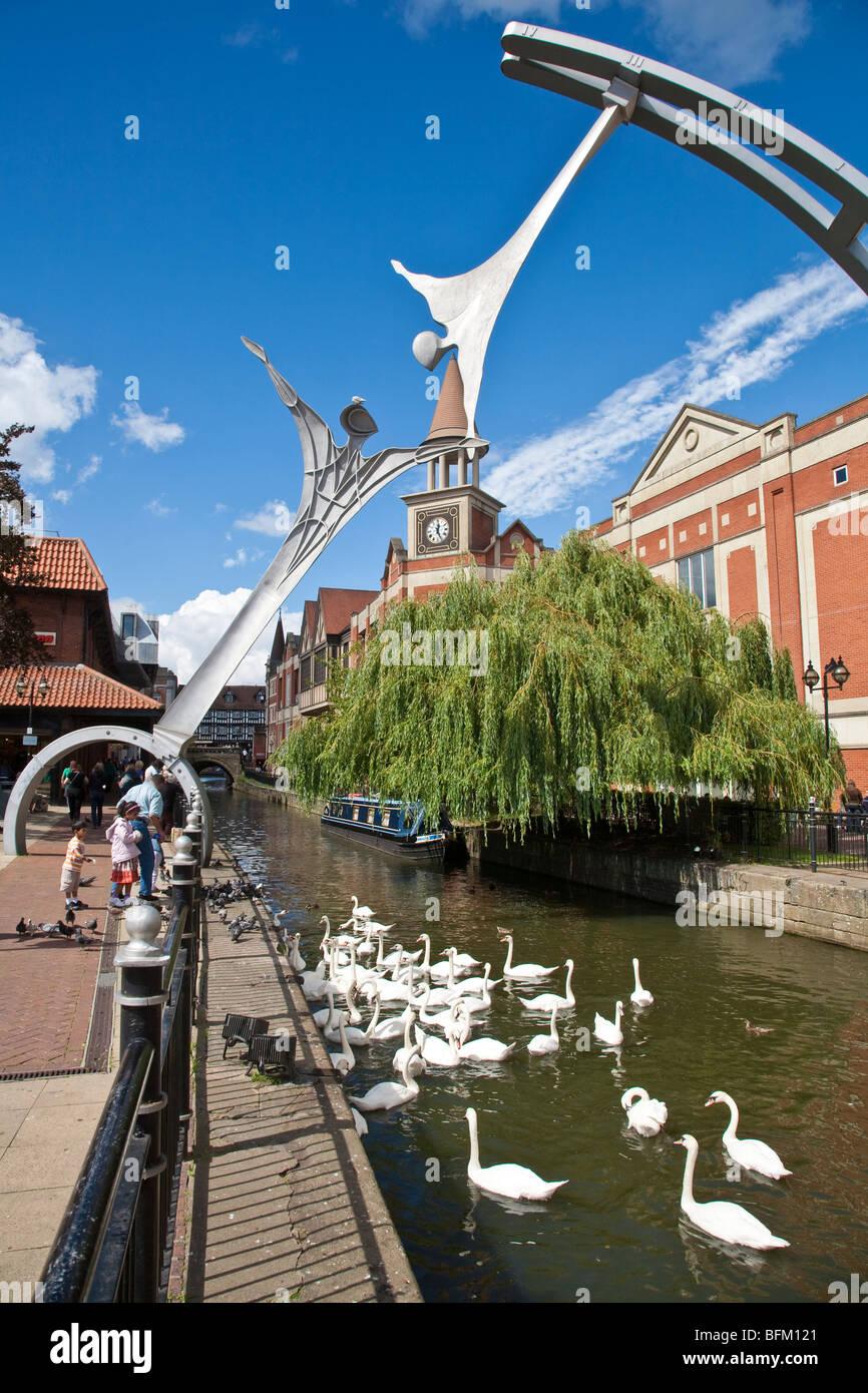 Empowerment Sculpture 2002, inspired by wind turbine blades, with Swans on River Witham, Waterside South, Lincoln Stock Photo