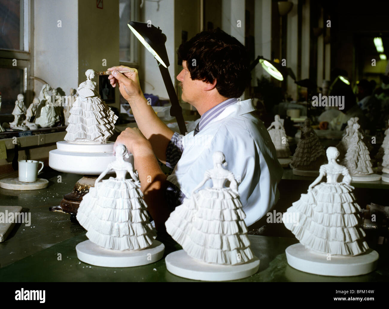 UK, England, Worcestershire, Royal Worcester factory worker assembling porcelain figurine Stock Photo