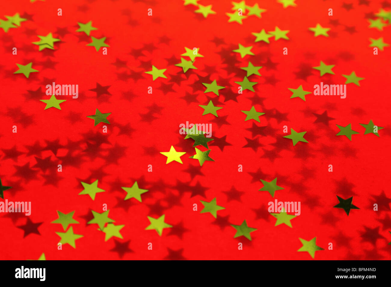 Old textured red holiday background with a gold stars Stock Photo