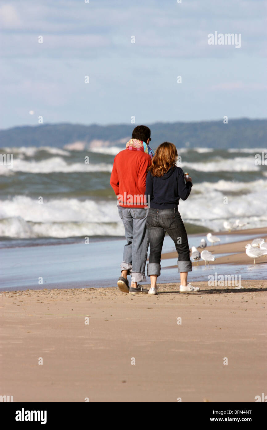 Couple walking on beach in New Buffalo, Michigan Stock Photo