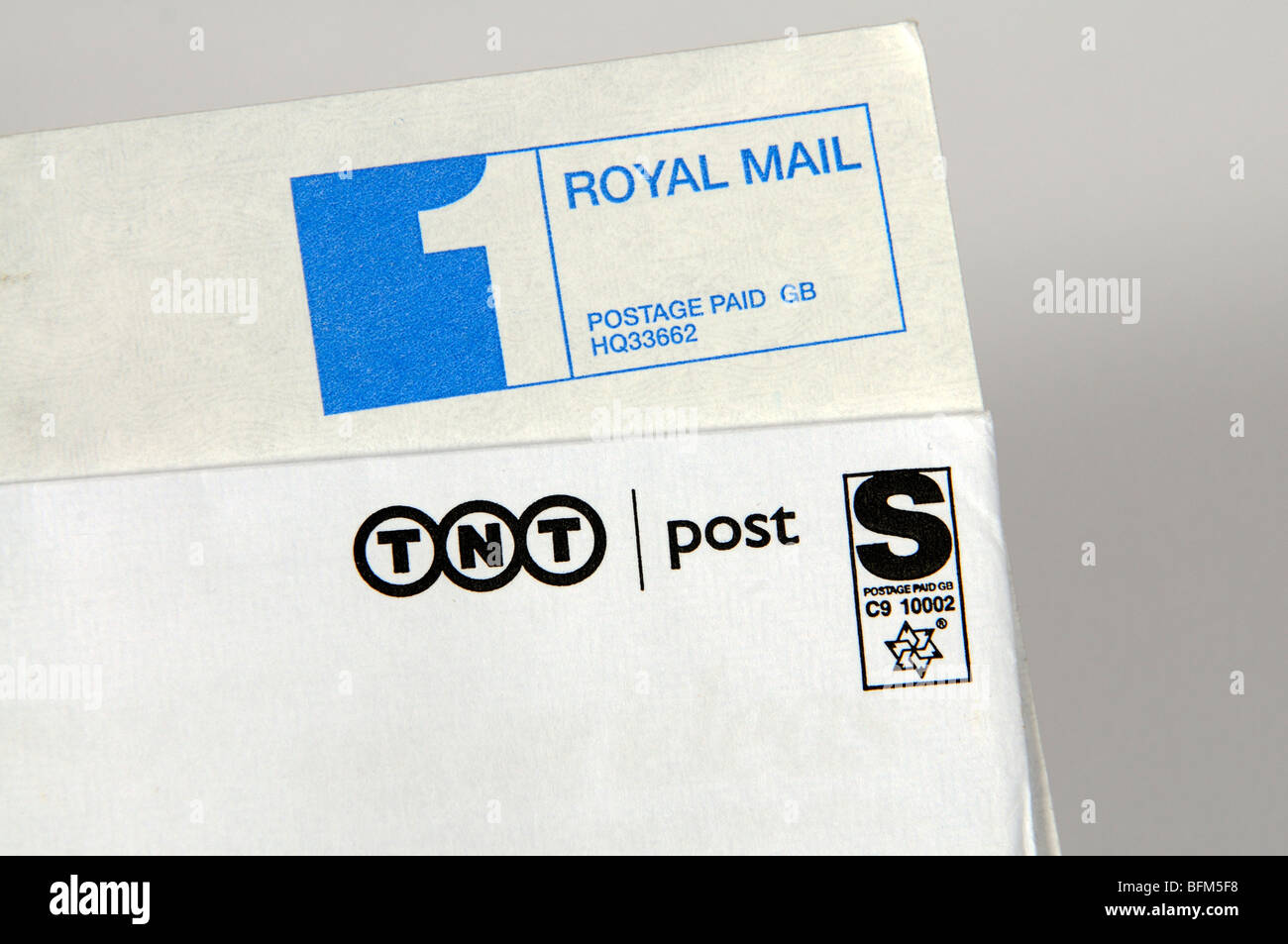 1st class postage paid Royal Mail label & competitor TNT Post label Stock Photo