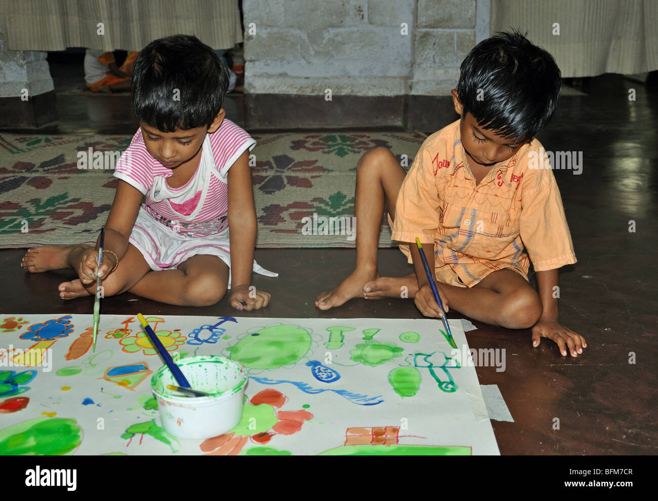 Children from a Montessori School in Rajarhat, West Bengal, India, taking part in a group painting workshop Stock Photo