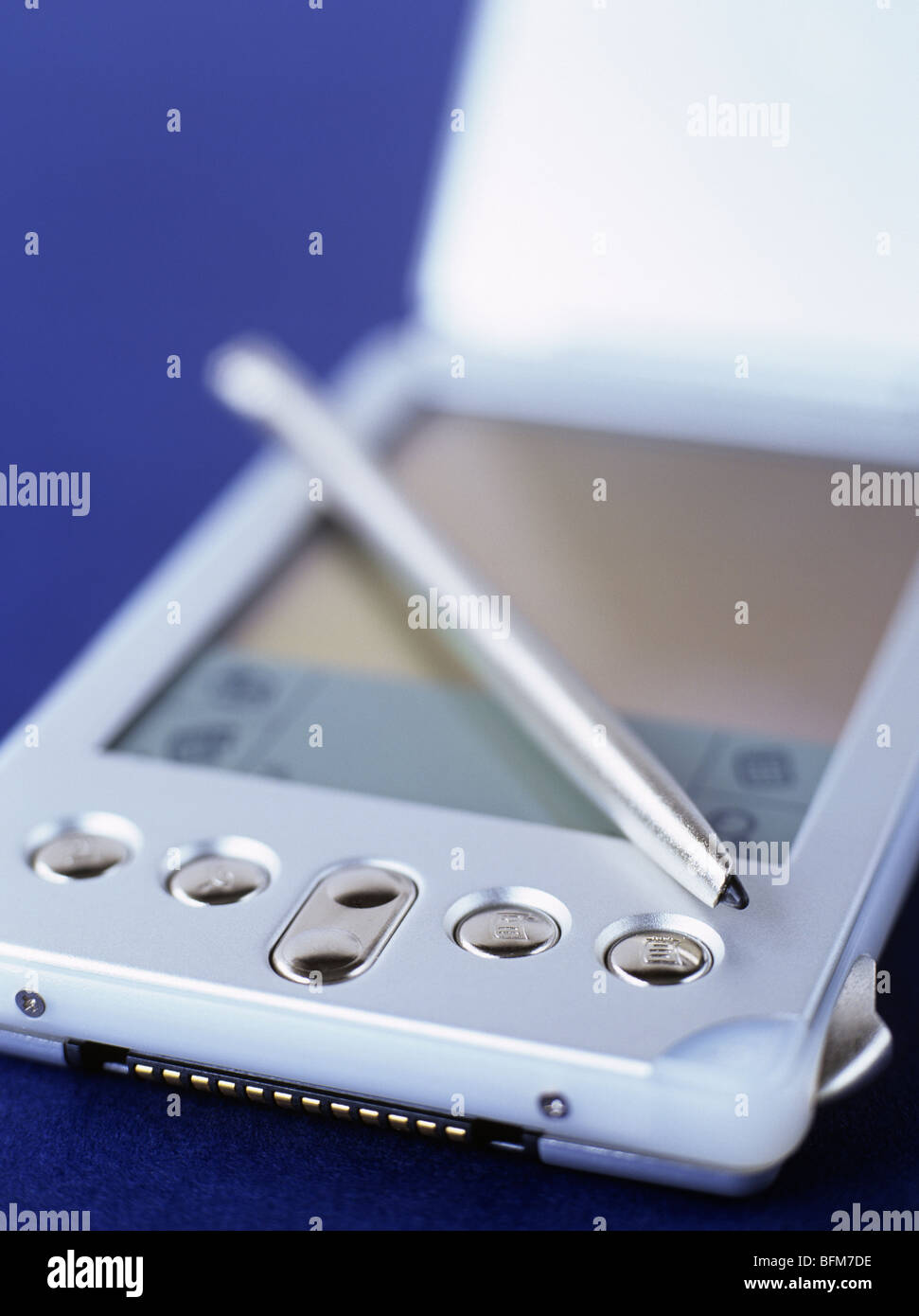 Close-up of a Handspring Visor Edge palmtop computer and stylus in metallic silver on blue Stock Photo