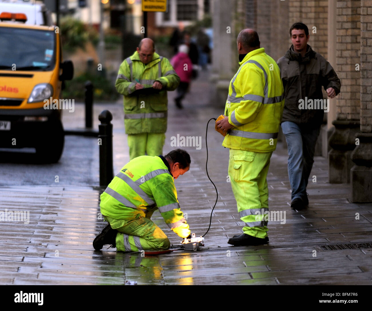 Workmen check over the pavement lighting in Brighton city centre UK Stock Photo