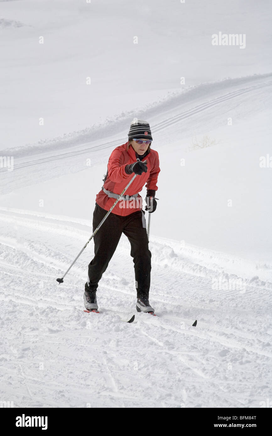 A senior citizen cross country or nordic skier on a groomed trail at Mount Bachelor in the Cascade Mountains of Oregon Stock Photo