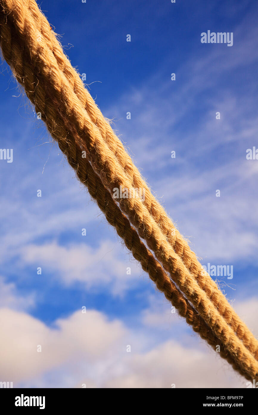 Multi strands of hemp rope with a blue sky and clouds behind. Stock Photo