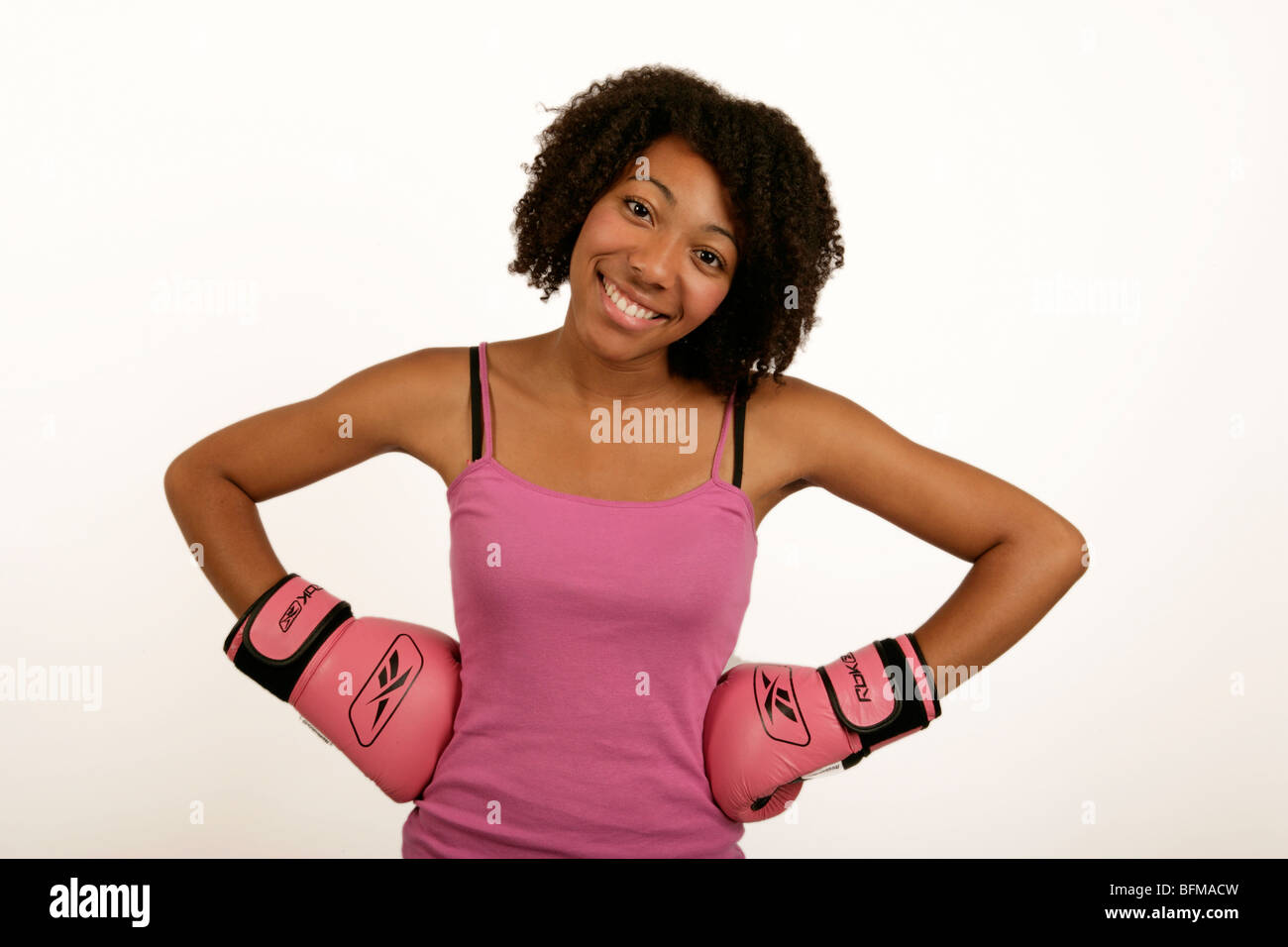 young african or afro Caribbean woman in pink boxing gloves keeping fit Stock Photo