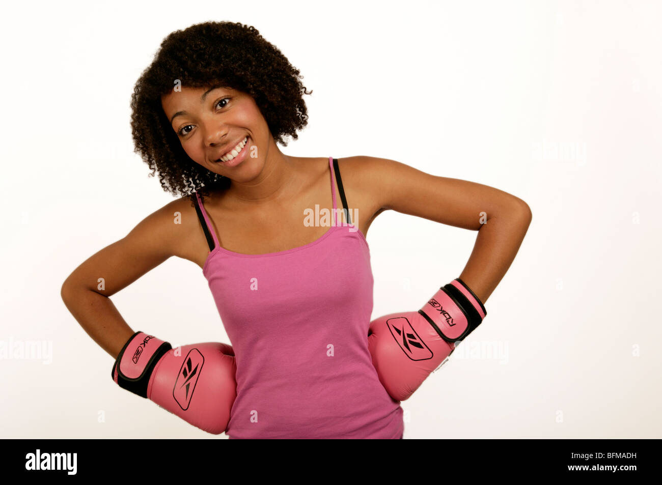 young african or afro Caribbean woman in pink boxing gloves keeping fit Stock Photo