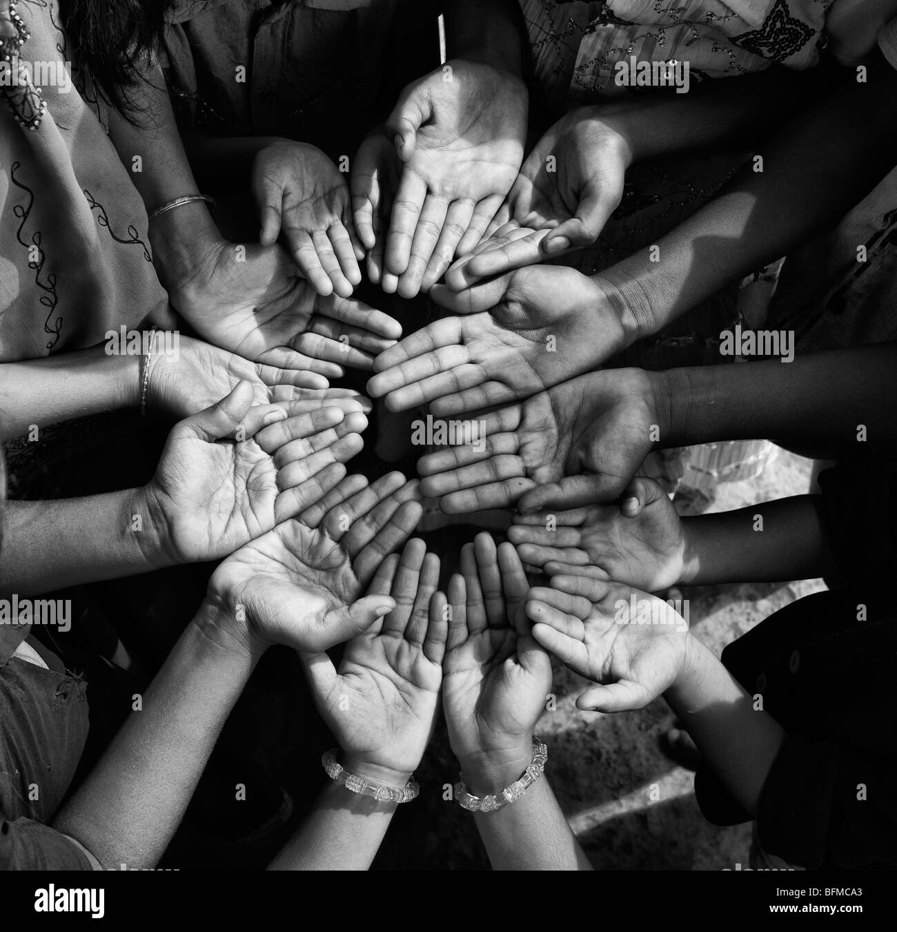Indian childrens hands in a circle. Black and White Stock Photo