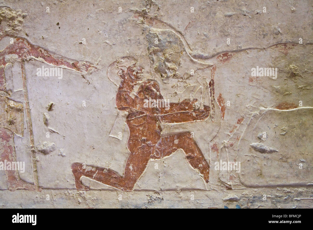 Relief of cow giving birth with aid of man in the Tombs at Meir , North West of Assyut in Middle Egypt Stock Photo