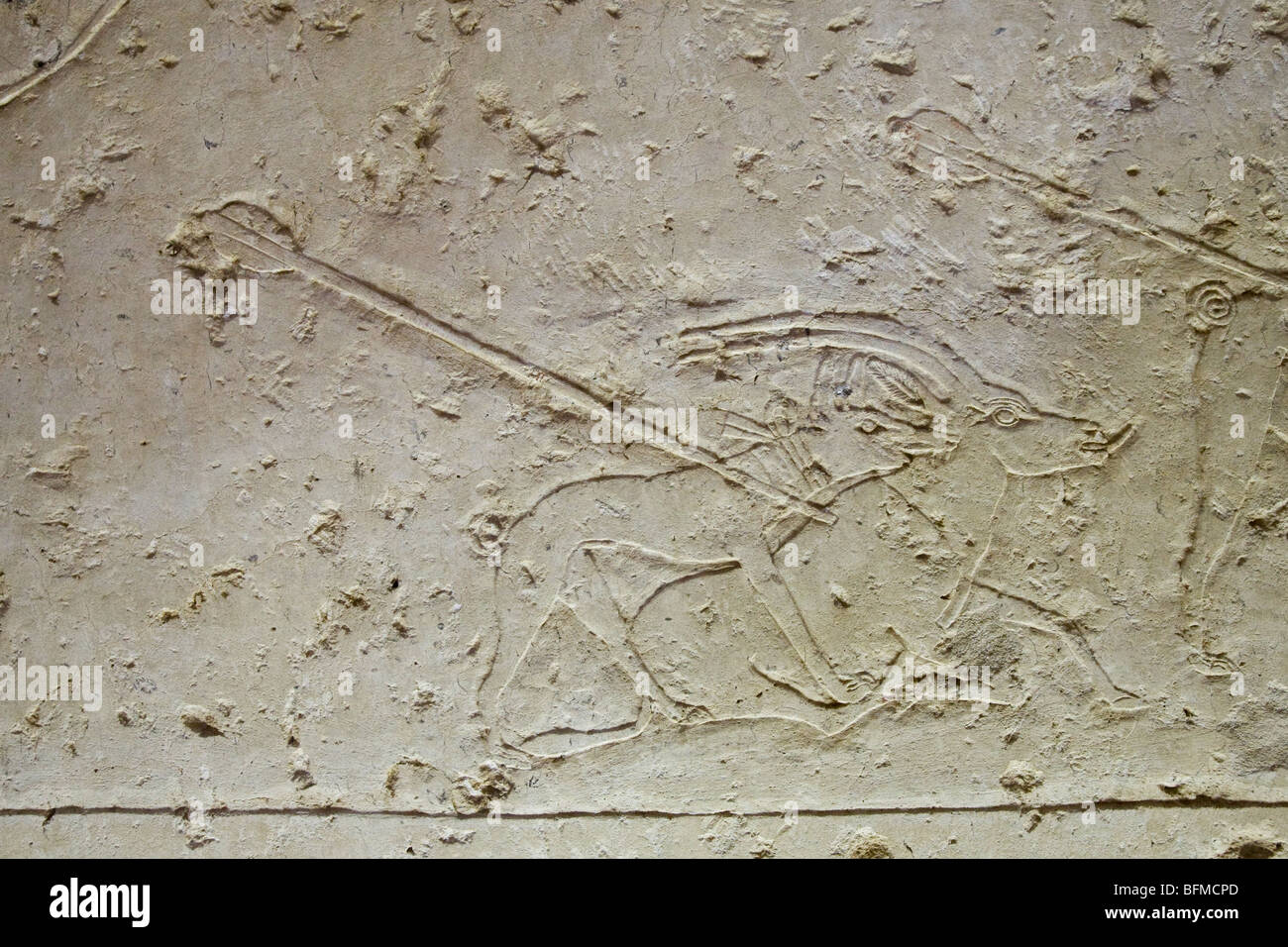 Relief of hunting dogs catching antelope speared by hunter in the Tombs at Meir , North West of Assyut in Middle Egypt Stock Photo